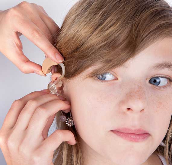 Young-Girl-Being-Fitted-for-Hearing-Aids-During-Speech-Testing