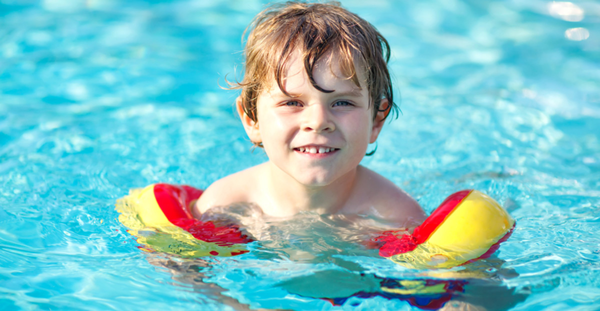 Young-Boy-Learning-How-to-Swim-With-Swim-Molds